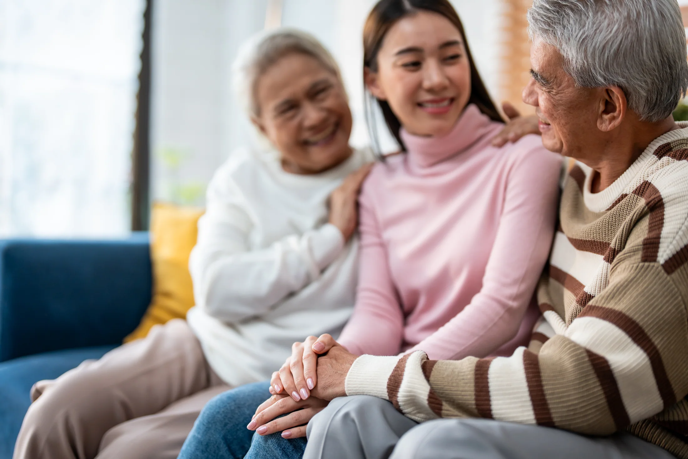 Family members enjoying a visit with an older relative at home
